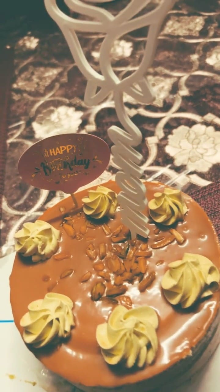 Video poster: a white printed Mom cake topper standing in a birthday cake